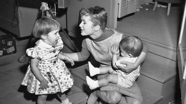 In this February 27, 1959, file photo, working long hours on the set of "Say One For Me," so she can fly to Spain and start another movie, actress Debbie Reynolds is visited at the studio by her children, Carrie, 2, and 1-year-old Todd. (AP File Photo) In this February 27, 1959, file photo, working long hours on the set of "Say One For Me," so she can fly to Spain and start another movie, actress Debbie Reynolds is visited at the studio by her children, Carrie, 2, and 1-year-old Todd. (AP File Photo)
