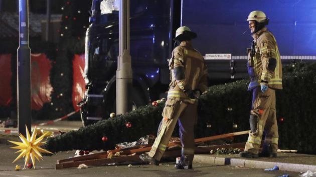 In this December 19, 2016 file photo firefighters look at a toppled Christmas tree after a truck ran into a crowded Christmas market in Berlin.(AP Photo) In this December 19, 2016 file photo firefighters look at a toppled Christmas tree after a truck ran into a crowded Christmas market in Berlin.(AP Photo)