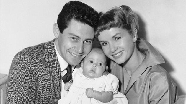In this January 2, 1957 file photo, Eddie Fisher and Debbie Reynolds hold their baby daughter, Carrie Frances Fisher, as the pose for a photo in the Hollywood area of Los Angeles. (AP File Photo) In this January 2, 1957 file photo, Eddie Fisher and Debbie Reynolds hold their baby daughter, Carrie Frances Fisher, as the pose for a photo in the Hollywood area of Los Angeles. (AP File Photo)