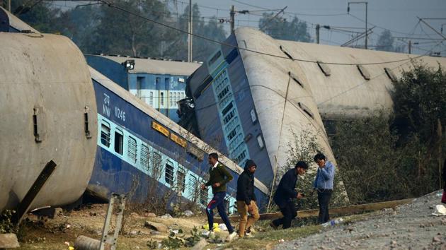 Officials and bystanders gather at the derailed train carriages at Rura, some 30 kms west of Kanpur on December 28, 2016, following a train crash in the northern Indian state of Uttar Pradesh.(AFP Photo) Officials and bystanders gather at the derailed train carriages at Rura, some 30 kms west of Kanpur on December 28, 2016, following a train crash in the northern Indian state of Uttar Pradesh.(AFP Photo)