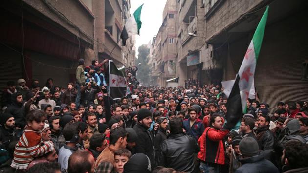Syrian demonstrators gather in the rebel-held town of Saqba, on the eastern outskirts of the capital Damascus, during a demonstration in solidarity with the inhabitants of the embattled Syrian city of Aleppo on December 16, 2016.(AFP) Syrian demonstrators gather in the rebel-held town of Saqba, on the eastern outskirts of the capital Damascus, during a demonstration in solidarity with the inhabitants of the embattled Syrian city of Aleppo on December 16, 2016.(AFP)