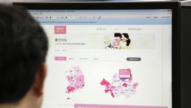 A journalist watches a screen showing a press release from the South Korean Ministry of the Interior about the birth map showing the number of women in childbearing age at his office in Seoul, South Korea.The letters at left top read "Birth Map." (AP Photo) A journalist watches a screen showing a press release from the South Korean Ministry of the Interior about the birth map showing the number of women in childbearing age at his office in Seoul, South Korea.The letters at left top read "Birth Map." (AP Photo)
