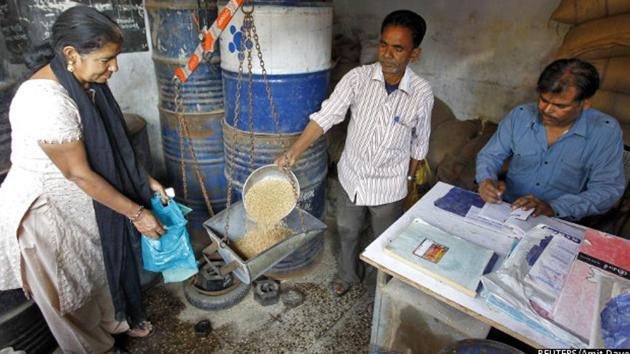 A woman buys wheat from a government-run ration shop in Ahmedabad, Gujarat. The government has identified over 23 million ineligible ration cards between 2013 and 2016, and 32.1% of the fair price shops have been automated under the end-to-end computerisation of targeted public distribution system, thereby checking subsidy leaks. (Reuters) A woman buys wheat from a government-run ration shop in Ahmedabad, Gujarat. The government has identified over 23 million ineligible ration cards between 2013 and 2016, and 32.1% of the fair price shops have been automated under the end-to-end computerisation of targeted public distribution system, thereby checking subsidy leaks. (Reuters)