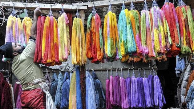 A Kashmiri man hangs dyed threads to dry at a dyeing centre in downtown Srinagar on December 26, 2016. Kashmiris have been dyeing fabric and threads manually for around two centuries and are known for their style of embroidery using these colourful threads. The practise though is on a decline as the manual labour is exhausting and takes a toll on workers. (Waseem Andrabi / Hindustan Times)