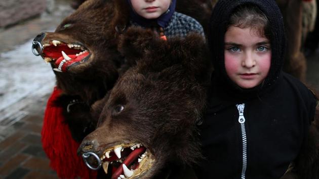 Children wearing costumes made of bearskins take part in a festival at Comanesti town in Romania on December 30, 2016. People from this region follow a pre-Christian rural tradition where they sing and dance in bear skin costumes to ward off evil. (Stoyan Nenov / REUTERS)