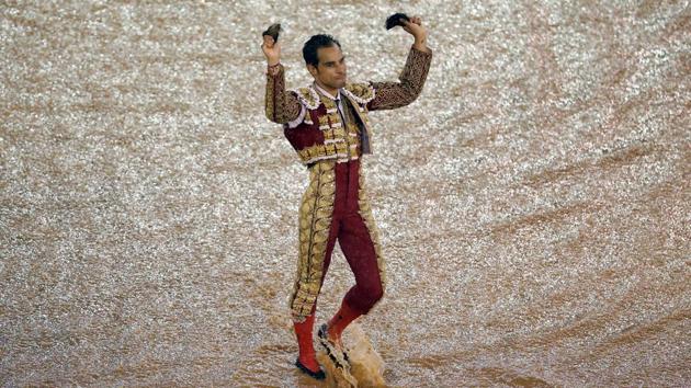 Colombian bullfighter Luis Bolivar celebrates with his trophy, two ears of a bull he killed. (Jaime Saldarriaga / REUTERS)