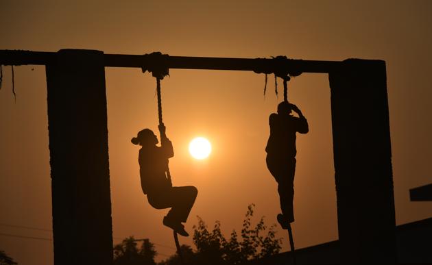 Rope climbing is one of the many tasks cadets training at the Delhi police academy in Dwarka must undergo every morning. (Raj K Raj/HT PHOTO)