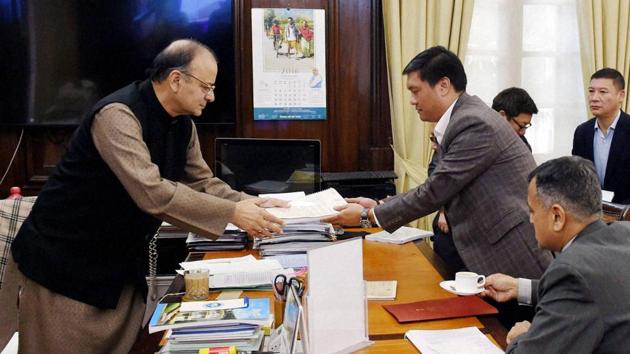 Union finance minister Arun Jaitley receives some documents from chief minister of Arunachal Pradesh Pema Khandu at his office in North Block in New Delhi on Thursday.(PTI)