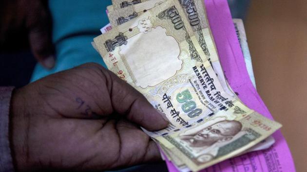 A person gives discontinued currency notes for depositing in a bank at Hyderabad.(AP File Photo) A person gives discontinued currency notes for depositing in a bank at Hyderabad.(AP File Photo)