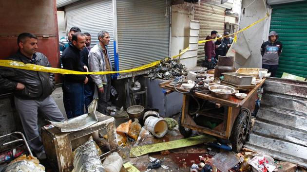 Iraqis look at the aftermath following a double bomb attack in a busy market area in Baghdad's central al-Sinek neighbourhood on December 31, 2016. (AFP) Iraqis look at the aftermath following a double bomb attack in a busy market area in Baghdad's central al-Sinek neighbourhood on December 31, 2016. (AFP)