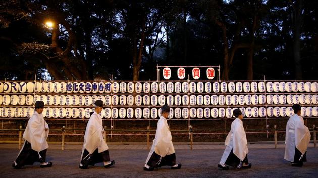 Shinto priests walk past lanterns after attending a ritual to usher in the upcoming New Year at the Meiji Shrine in Tokyo (Reuters) Shinto priests walk past lanterns after attending a ritual to usher in the upcoming New Year at the Meiji Shrine in Tokyo (Reuters)