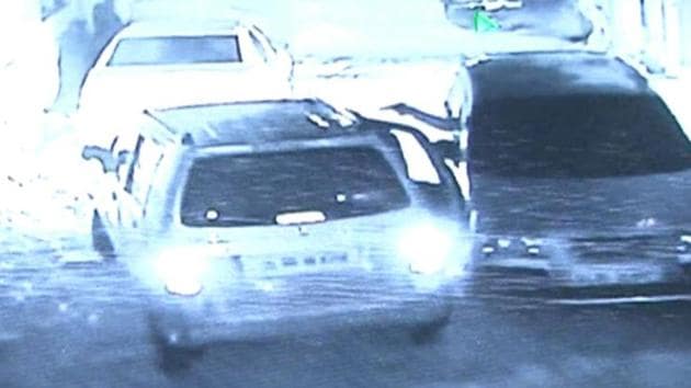 A CCTV grab shows the assailants in a car (right) shooting at the DTTDC wine shop manager in the car on left. (HT Photo) A CCTV grab shows the assailants in a car (right) shooting at the DTTDC wine shop manager in the car on left. (HT Photo)