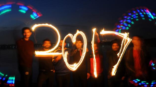 People project 2017 with lighted candles as they celebrate the New Year’s Eve near Sukhna lake in Chandigarh. (Anil Dayal/HT Photo) 