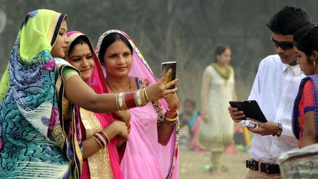 Women take a selfie at Maidan in Kolkata on Sunday. (Ashok Nath Dey/HT PHOTO) 