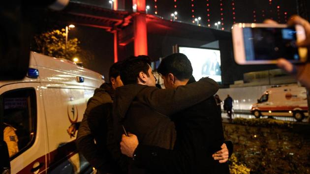 Youths embrace near the scene of an attack in Istanbul, on New Year's Day, early Sunday, Jan. 1, 2017. An assailant believed to have been dressed in a Santa Claus costume and armed with a long-barrelled weapon, opened fire at a nightclub in Istanbul's Ortakoy district during New Year's celebrations, killing dozens of people and wounding dozens of others in what the province's governor described as a terror attack. (Depo Photos via AP) (AP) Youths embrace near the scene of an attack in Istanbul, on New Year's Day, early Sunday, Jan. 1, 2017. An assailant believed to have been dressed in a Santa Claus costume and armed with a long-barrelled weapon, opened fire at a nightclub in Istanbul's Ortakoy district during New Year's celebrations, killing dozens of people and wounding dozens of others in what the province's governor described as a terror attack. (Depo Photos via AP) (AP)