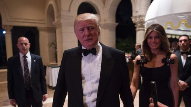 US President-elect Donald Trump answers questions from reporters accompanied by his wife Melania for a New Year's Eve party December 31. (AFP Photo) US President-elect Donald Trump answers questions from reporters accompanied by his wife Melania for a New Year's Eve party December 31. (AFP Photo)