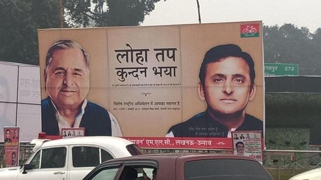 Uttar Pradesh chief minister Akhilesh Yadav and party chief Mulayam Singh Yadav pictured on a hoarding in Lucknow.(HT Photo)