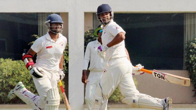 Gujarat batsman R P Singh with Rujul Bhat running between the wicket during the Ranji Trophy semifinal cricket match against Jharkhand at VCA stadium in Nagpur.(PTI)