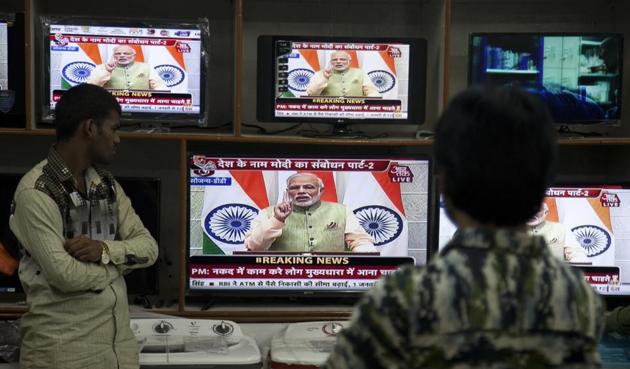 People watch Prime Minister Narendra Modi’s address to the nation on December 31. (AP photo) People watch Prime Minister Narendra Modi’s address to the nation on December 31. (AP photo)