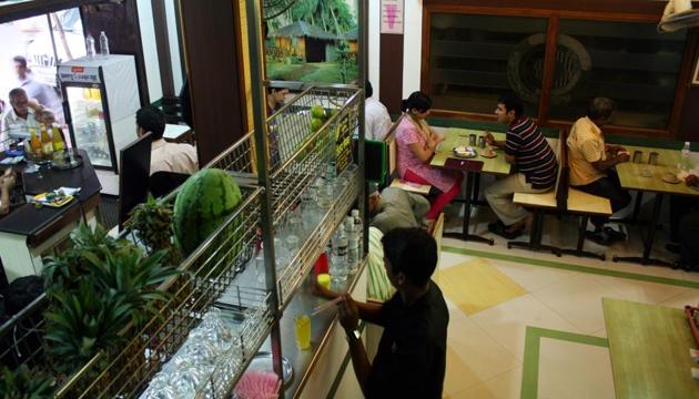 People enjoy their food at a restaurant in Mumbai.