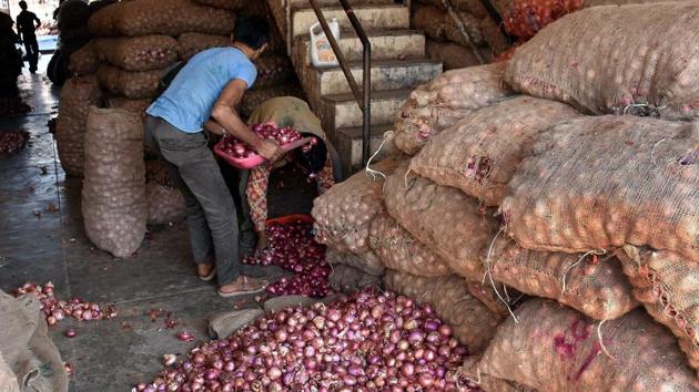 Labourers unload onion sacks. (PTI file photo) Labourers unload onion sacks. (PTI file photo)