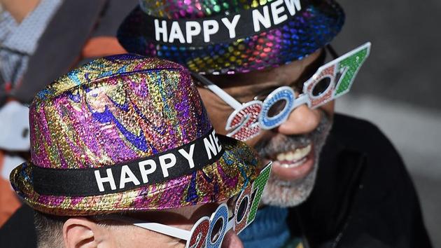 Two parade-goers wearing New Year's hats and glasses await the start of the 128th Rose Parade. (AFP Photo) Two parade-goers wearing New Year's hats and glasses await the start of the 128th Rose Parade. (AFP Photo)