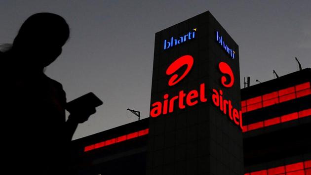 A girl checks her mobile phone as she walks past the Bharti Airtel office building in Gurgaon. (Reuters file photo) A girl checks her mobile phone as she walks past the Bharti Airtel office building in Gurgaon. (Reuters file photo)