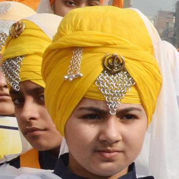 Students in a nagar kirtan during the 350th birth anniversary celebrations of Guru Gobind Singh, in Amritsar on Tuesday. (Sameer Sehgal/HT)