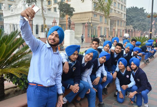 Students of schools under the Chief Khalsa Diwan take a selfie during a nagar kirtan to mark the 350th birth anniversary celebrations of Guru Gobind Singh, in Amritsar on Tuesday. (Sameer Sehgal/HT)
