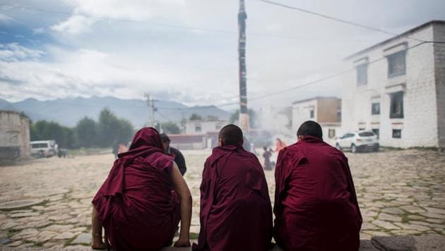 Monks sit in front of the Buddhist Sera monastery in the regional capital Lhasa, Tibet.(AFP File Photo)