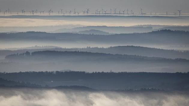 Wind turbines seen on the horizon as the peaks of Taunus foothills rise out of the fog-covered valleys at Grosser Feldberg near Frankfurt, central Germany. (Frank Rumpenhorst/AP)