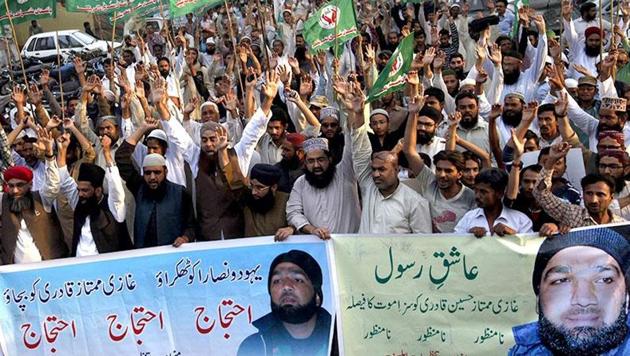 In this March 2015 file photo, supporters of a religious political party shout slogans during a demonstration against the sentence of convicted killer Mumtaz Qadri in Karachi. He killed Punjab governor Salman Taseer because he championed the case of a Christian woman, Asia Bibi, who was sentenced to death under the blasphemy laws. (Reuters File) In this March 2015 file photo, supporters of a religious political party shout slogans during a demonstration against the sentence of convicted killer Mumtaz Qadri in Karachi. He killed Punjab governor Salman Taseer because he championed the case of a Christian woman, Asia Bibi, who was sentenced to death under the blasphemy laws. (Reuters File)