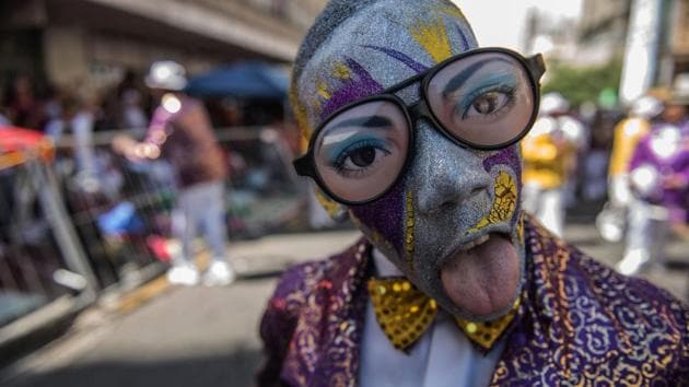 A disguised and painted man sticks his tongue as Cape Minstrels from different troops perform during the traditional Second New Year Parade in the streets of central Cape Town, South Africa. The Kaapse Klopse (or simply Klopse) is a minstrel festival that takes place annually. It is also referred to as Tweede Nuwe jaar (Second New Year). (Mujahid Safodien/AFP) A disguised and painted man sticks his tongue as Cape Minstrels from different troops perform during the traditional Second New Year Parade in the streets of central Cape Town, South Africa. The Kaapse Klopse (or simply Klopse) is a minstrel festival that takes place annually. It is also referred to as Tweede Nuwe jaar (Second New Year). (Mujahid Safodien/AFP)