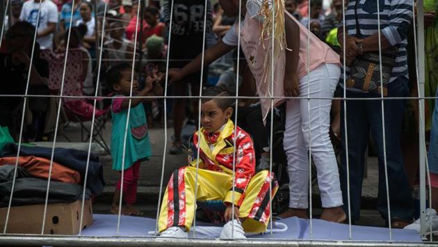 A child looks at the minstrels during the traditional Second New Year Parade in Cape Town, South Africa. (Mujahid Safodien/AFP) A child looks at the minstrels during the traditional Second New Year Parade in Cape Town, South Africa. (Mujahid Safodien/AFP)