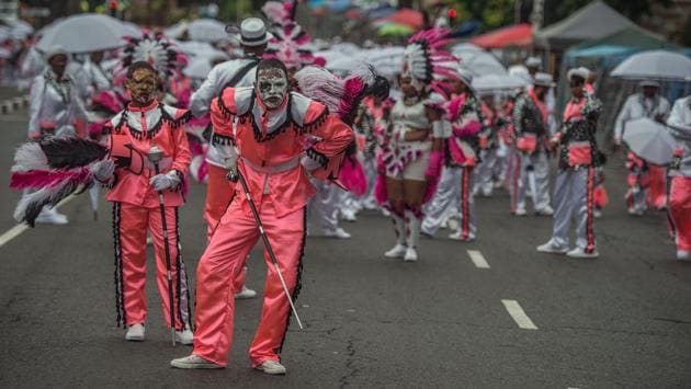 People in disguise join the traditional Second New Year Parade. The festival is considered as a rite of renewal that has been shaped by the Cape’s history. (Mujahid Safodien/AFP) People in disguise join the traditional Second New Year Parade. The festival is considered as a rite of renewal that has been shaped by the Cape’s history. (Mujahid Safodien/AFP)