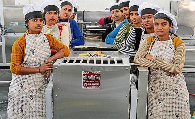 Workers engaged under the Annapurna Akshayapatra Yojana in the kitchen set up at Karuna Sadan, Sector 11, Chandigarh, on Tuesday.(Karun Sharma/HT)