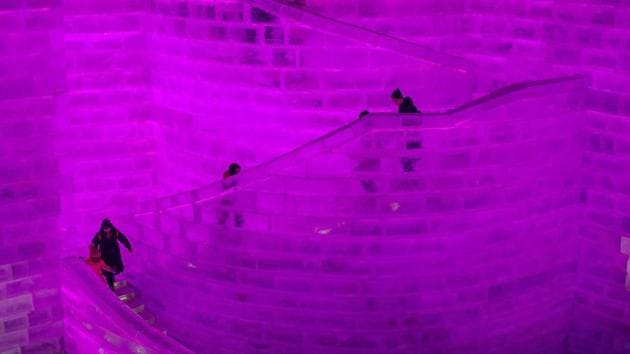 People visit ice sculptures illuminated by coloured lights at the Harbin Ice and Snow Festival to celebrate the new year in Harbin on January 4, 2017. (NICOLAS ASFOURI / AFP)