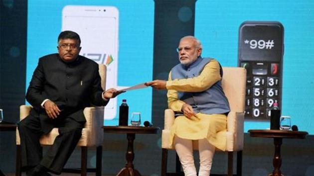 Prime Minister Narendra Modi and Union Minister IT and communications, Ravi Shanker Prasad at the launch of a new mobile app 'Bhim' to encourage e-transactions at Talkatora Stadium in New Delhi.(PTI) Prime Minister Narendra Modi and Union Minister IT and communications, Ravi Shanker Prasad at the launch of a new mobile app 'Bhim' to encourage e-transactions at Talkatora Stadium in New Delhi.(PTI)