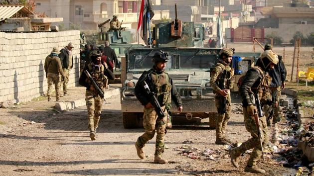 Iraqi rapid response forces gather during battle with Islamic State militants in the Mithaq district of eastern Mosul, Iraq, on Wednesday. (Reuters) Iraqi rapid response forces gather during battle with Islamic State militants in the Mithaq district of eastern Mosul, Iraq, on Wednesday. (Reuters)