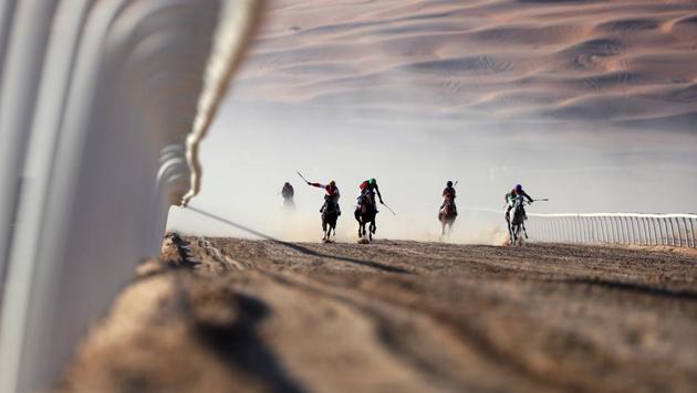 Jockeys compete in a race for purebred Arab horses during the Liwa 2017 Moreeb Dune Festival at the Liwa desert, some 250 kilometres west of the Gulf emirate of Abu Dhabi. (Karim Sahib/AFP) Jockeys compete in a race for purebred Arab horses during the Liwa 2017 Moreeb Dune Festival at the Liwa desert, some 250 kilometres west of the Gulf emirate of Abu Dhabi. (Karim Sahib/AFP)