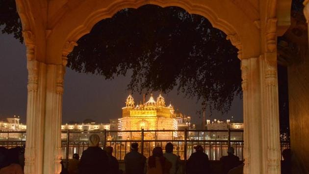 An illuminated Golden Temple on the occasion of 350th birth anniversary of Guru Gobind Singh in Amritsar on Thursday. (Sameer Sehgal/HT Photo)