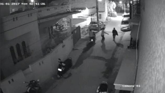 Two men on a scooter assault a woman, attempting to take off her clothes and pushing her to the ground before leaving, in Bengaluru, India, in this still image taken from January 1, 2017 CCTV footage. (REUTERS)