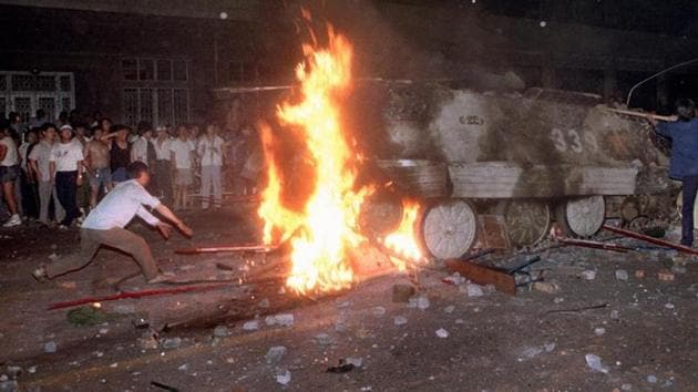File photo of a student protester putting barricades in the path of an already burning armoured personnel carrier that rammed through student lines during an army attack on anti-government demonstrators in Beijing's Tiananmen Square on June 4, 1989. (AP) File photo of a student protester putting barricades in the path of an already burning armoured personnel carrier that rammed through student lines during an army attack on anti-government demonstrators in Beijing's Tiananmen Square on June 4, 1989. (AP)