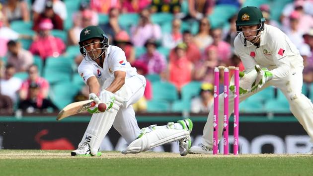 Pakistan batsman Younis Khan sweeps a ball as Australia's wicketkeeper Peter Handscomb looks on during the third day of the third cricket Test match at the SCG in Sydney on Thursday. Younis Khan remained unbeaten on 175 in Pakistan’s first innings.(AFP)