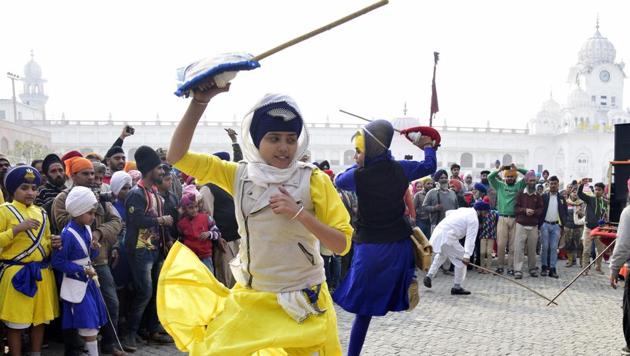 Devotees showcase martial performances during the Nagar Kirtan in Patiala on Wednesday. (Bharat Bhushan  / HT Photo) 