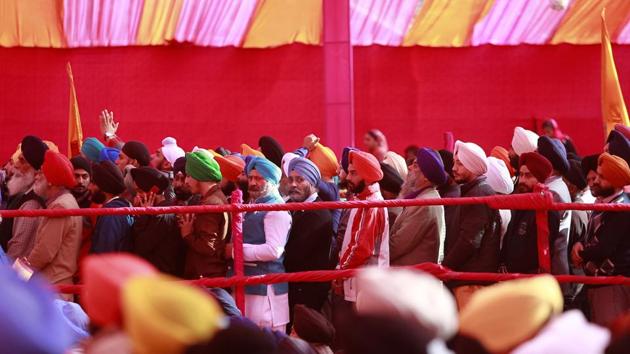 Sikh devotees stand in a queue to pay obeisance at a Gurudwara  in Jammu on Thursday. (Channi Anand / AP) 