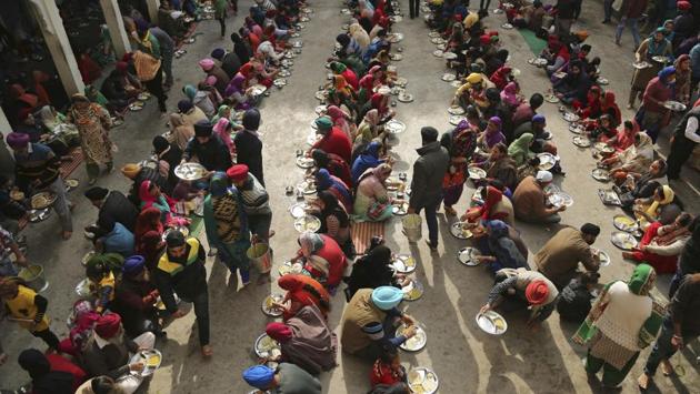 Sikh devotees eat a meal from a community kitchen at a Gurudwara in Jammu, on the birth anniversary of Guru Gobind Singh. (Channi Anand/ AP PhoTO) 