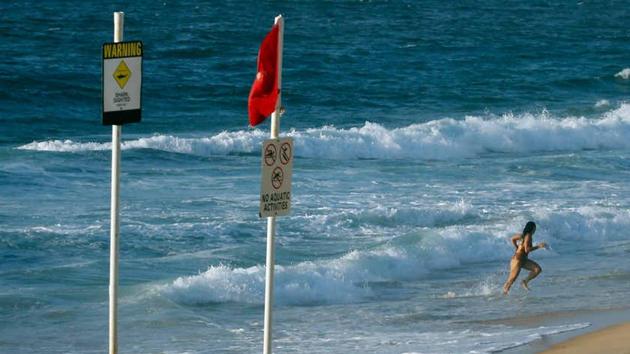File photo of a woman running from the water on a beach in Newcastle, Australia, in January 2015. (REUTERS) File photo of a woman running from the water on a beach in Newcastle, Australia, in January 2015. (REUTERS)