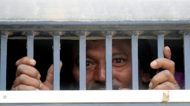 An Indian fisherman stands in a prison van on his arrival at the railway station in Karachi, after his release from prison. (AFP Photo) An Indian fisherman stands in a prison van on his arrival at the railway station in Karachi, after his release from prison. (AFP Photo)