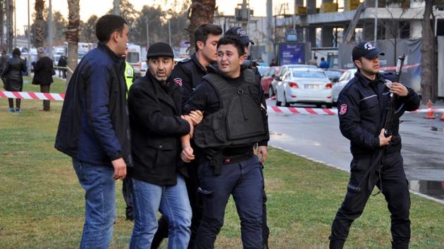 This photo obtained from the photo agency Depo Photos shows a police officer (C) crying and reacting while being evacuated after a colleague was killed at the site of an explosion in front of the courthouse in Izmir on Wednesday.(AFP)